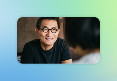 a man wearing glasses and smiling