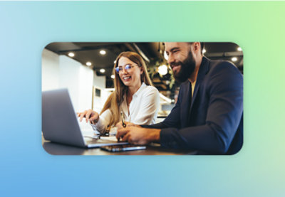 A man and woman looking at a laptop