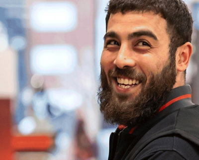 A man with a beard smiling.