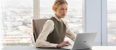 A woman sitting at a desk using a laptop.