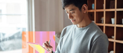 A man writing on a clipboard.