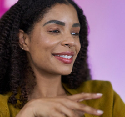 Modern, empty office space with tiled floors, white walls, and large windows letting in natural light