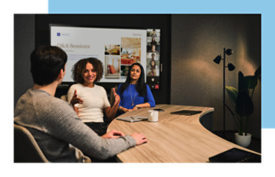 Two women and a man discussing about work.