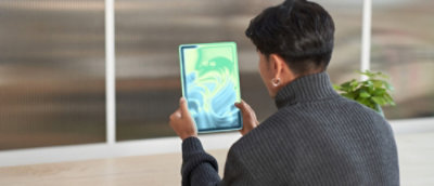 A person holding a tablet.