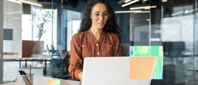 A person in glasses using a laptop.