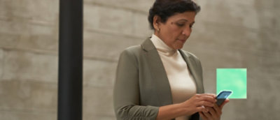 A woman wearing a green jacket.