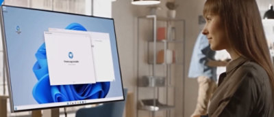 A person looking at a computer screen displaying a blue rose.