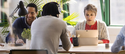 Three people working on their tablets