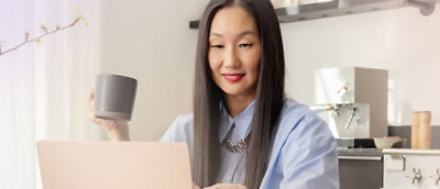 A woman with long hair holding a cup.