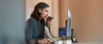 A person sitting at a desk using a computer.