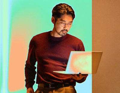 A blurry image of a laptop being held.