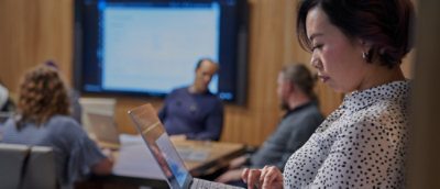 A woman looking at a laptop.