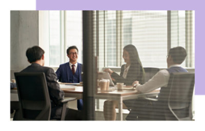 group of people sitting on a round table and discussing