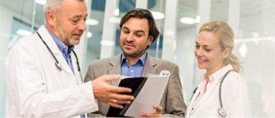 A man in a suit holding a folder.