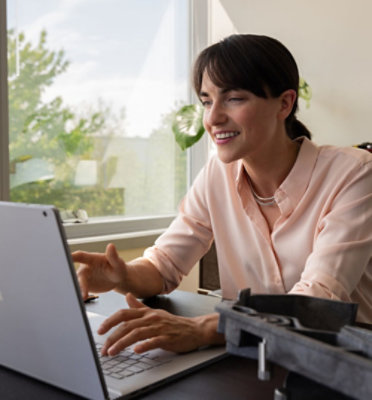 A woman using a laptop.