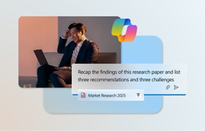 A man sitting on a couch with a laptop with market research information displayed on the screen.