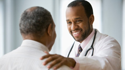 A close-up of a doctor smiling.