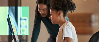 A women and a man looking into computer screen