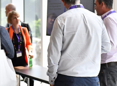 A man and woman standing at a table.