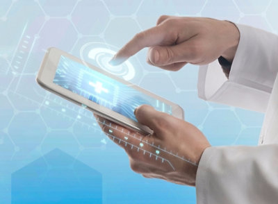 A close-up of a hand holding a tablet.