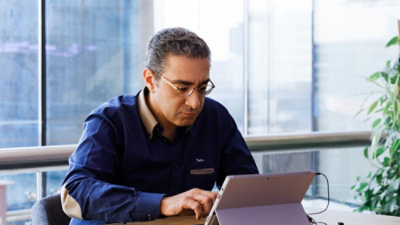  A man working at a tablet.