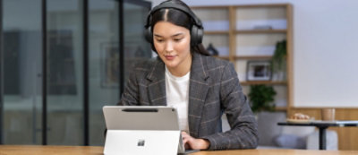 A woman with headphones on a video call.