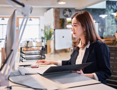 A woman sitting at a desk.