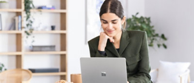 A woman sitting at a laptop on a desk.