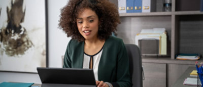 A woman sitting and working on her laptop