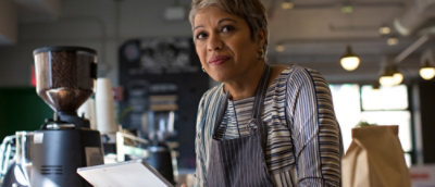 A woman wearing a grey cooking apron