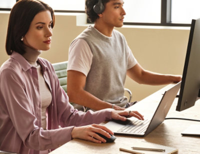 Two persons working on computers