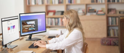 A person sitting at a desk using a computer.