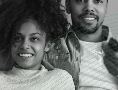 Black and white photo of a person in a denim jacket holding a girl