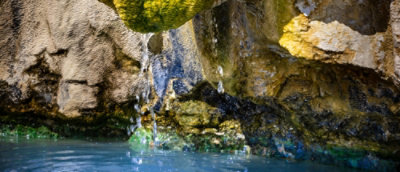 Rocks besides water and water falling from rocks