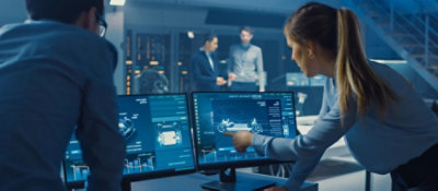 A person pointing at a computer screen.