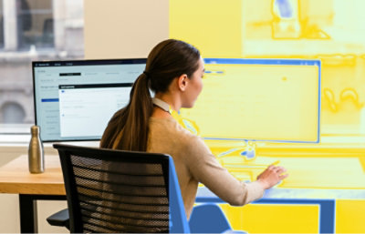 A person sitting at a desk with a computer screen in view.