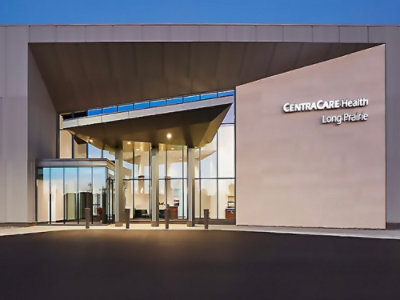 A building with glass walls and doors displaying the text CENTRACARE Health Long Prairie.