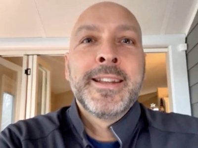 A close-up of a bearded man's face.