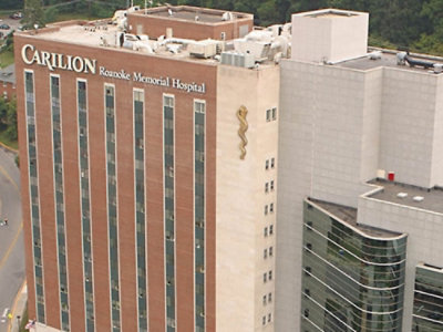 A high angle view of a hospital building with the text CARILION Roanoke Memorial Hospital visible.