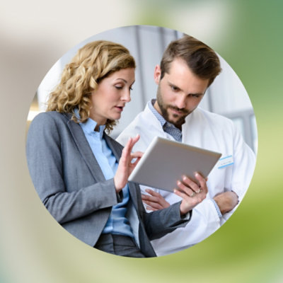 A man and woman looking at a tablet together.