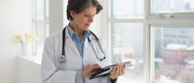 A doctor holding a tablet.