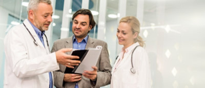 A group of doctors looking at a file.