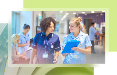 A group of nurses talking together indoors.