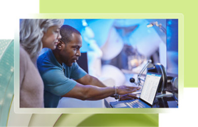 A man and woman looking at a laptop.