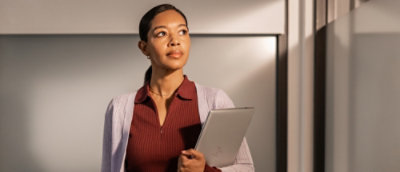 Confident women holding a laptop.