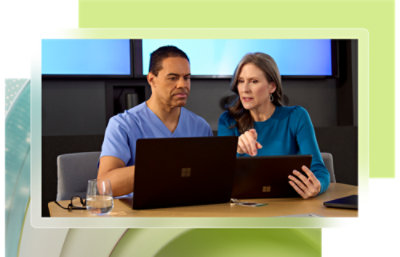 A man and a woman looking at laptops.