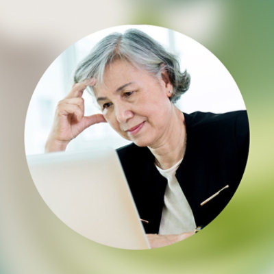 A woman looking at a laptop.