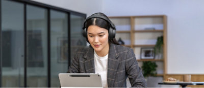 A woman sitting at a desk using a laptop.