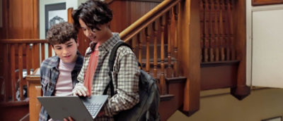 Two people looking at the laptop screen