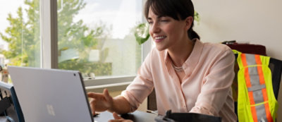A woman looking at her laptop.